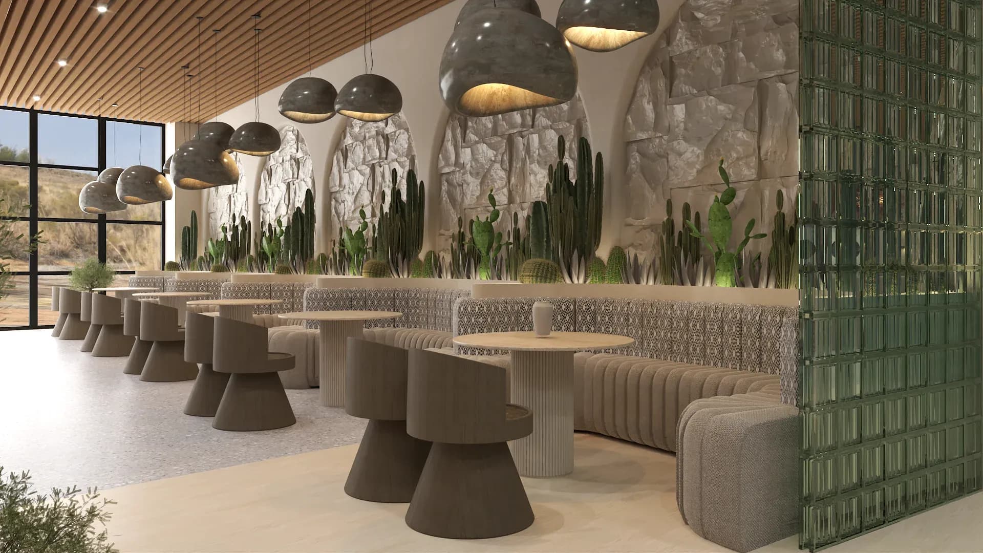 Desert restaurant bar area with sage green upholstered bar stools, natural stone wall with cactus niches, stone mushroom pendant lights, round pedestal tables, wood slat ceiling, and desert landscape view through windows designed by Debora Interiors