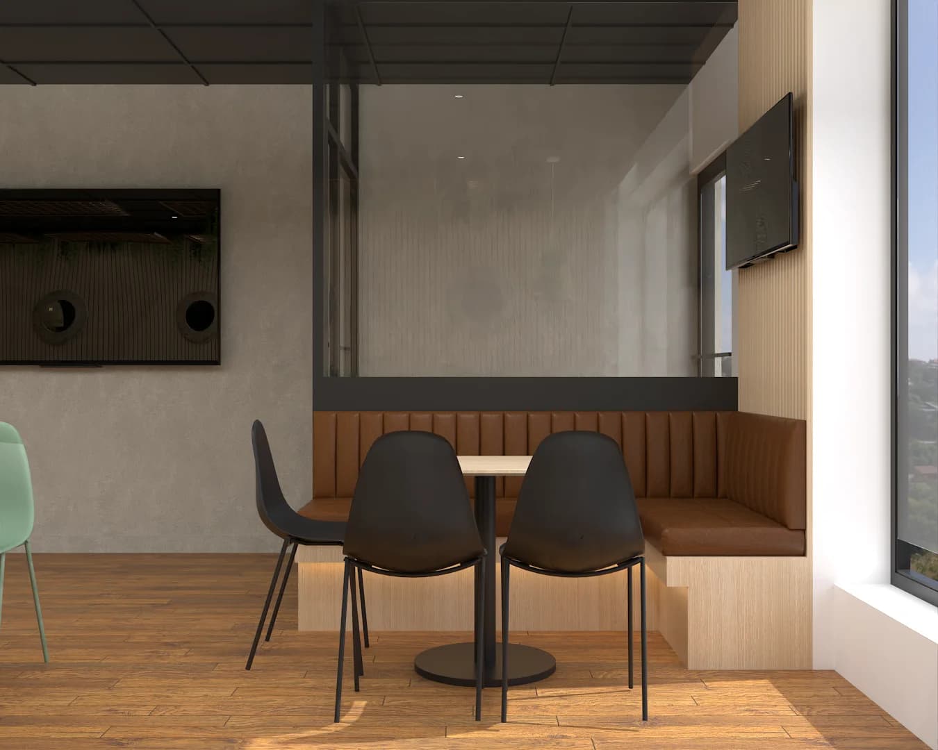 Booth corner with gray banquette, black chairs, small table, and wall-mounted TVs