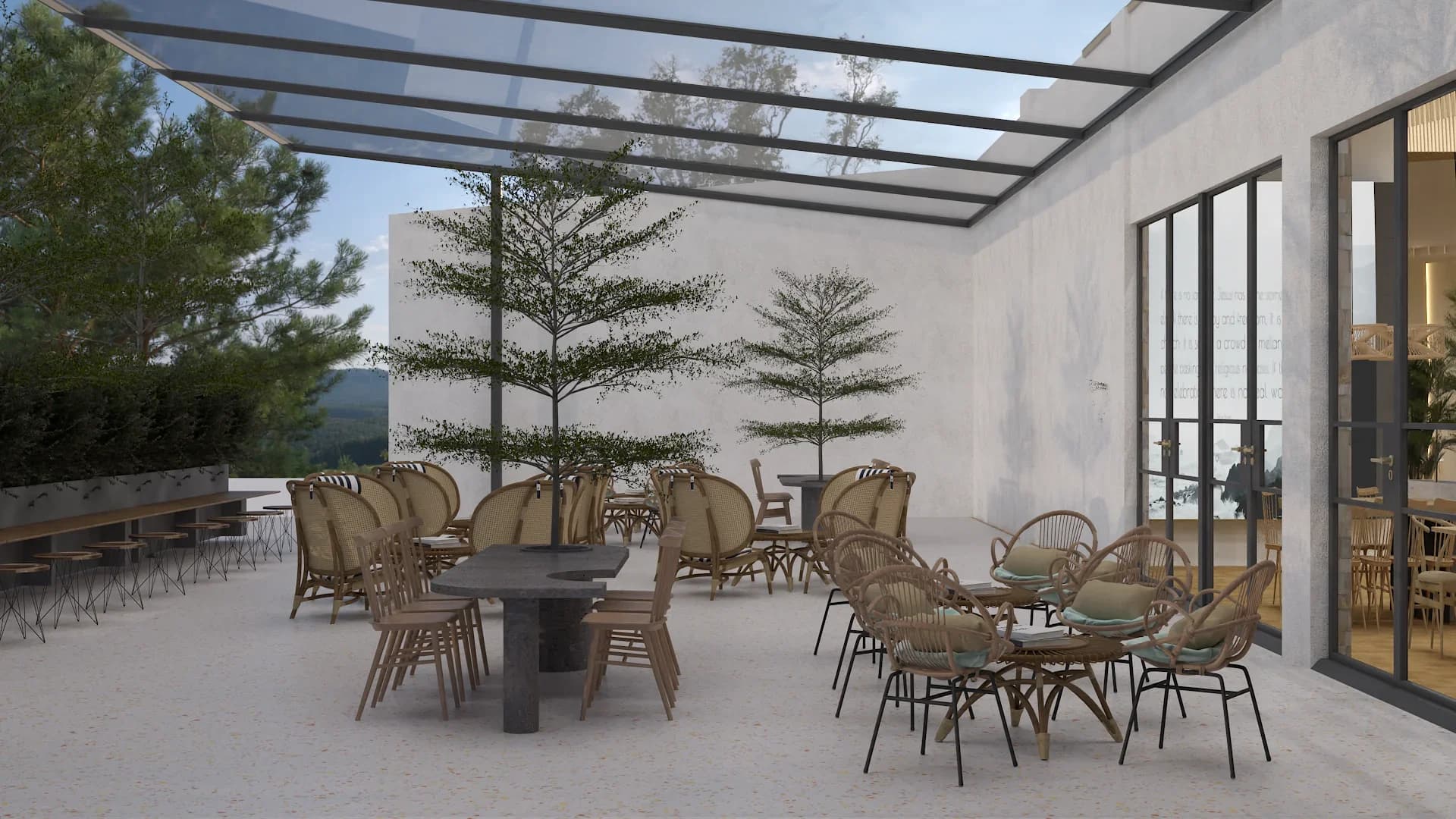Open-air restaurant terrace with glass canopy roof, rattan armchairs with beige cushions, dark concrete pedestal tables, slender trees planted in the courtyard, white stucco walls, wooden bench seating along the perimeter, black steel-framed windows, and light gravel flooring