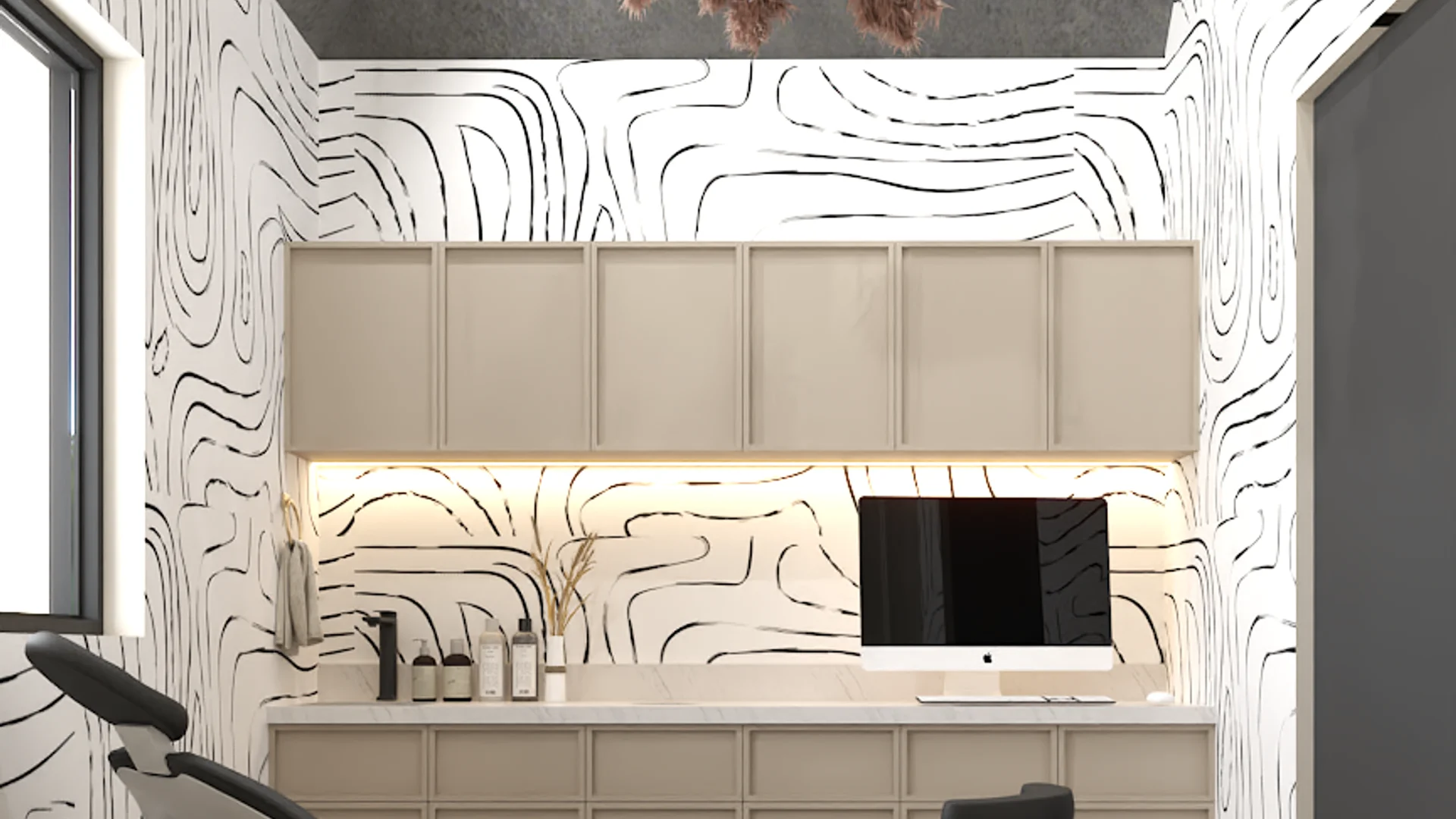 Treatment room with black and white swirl wallpaper, beige upper cabinets, under-cabinet lighting, and built-in workstation
