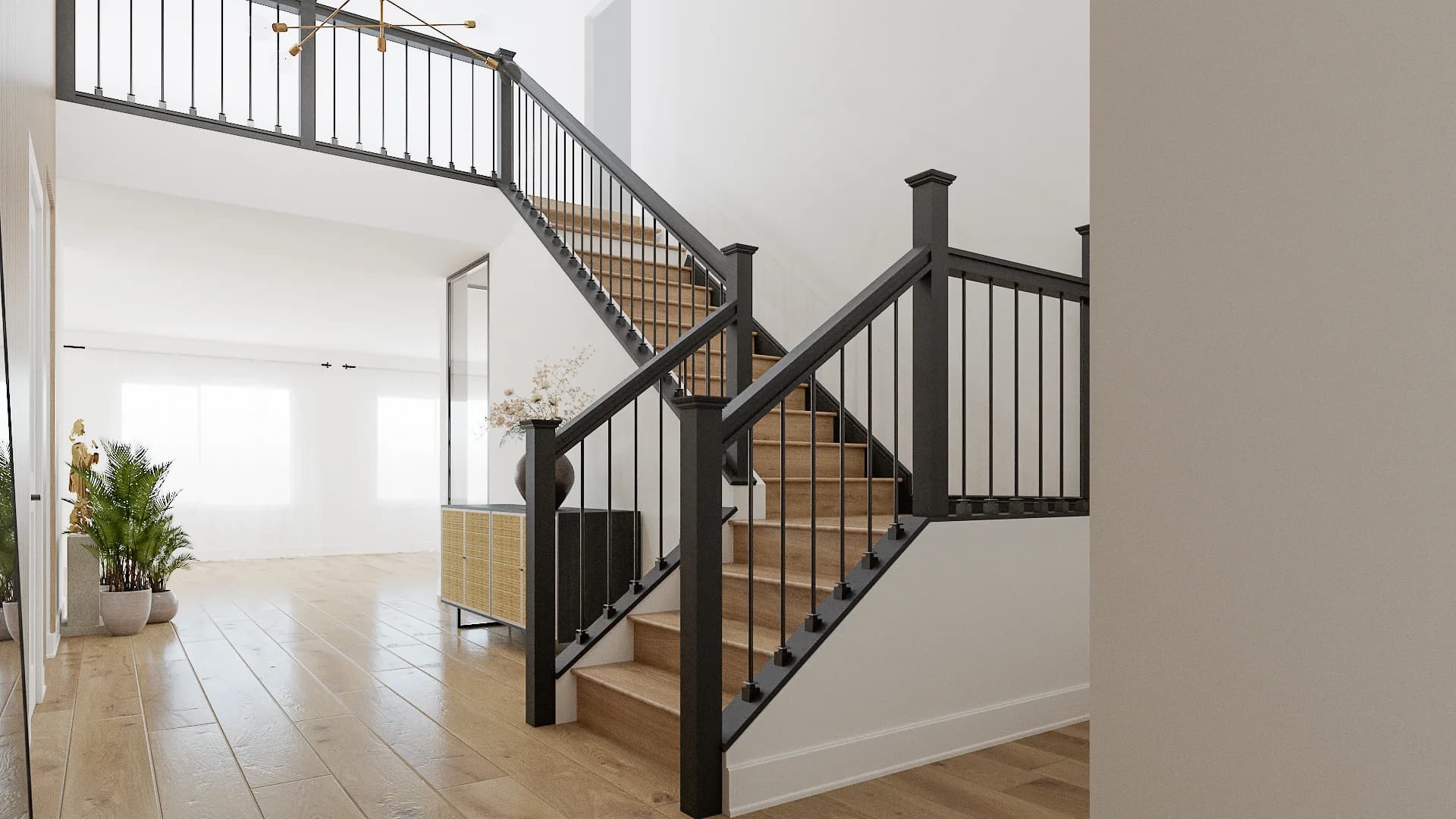 Open foyer staircase with black metal balusters, oak treads, white risers, and wide-plank hardwood flooring