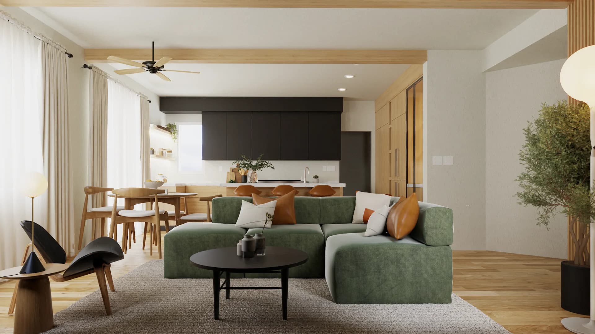 Open-plan studio with green velvet sectional, black kitchen cabinets, warm oak floors, and cognac leather stools