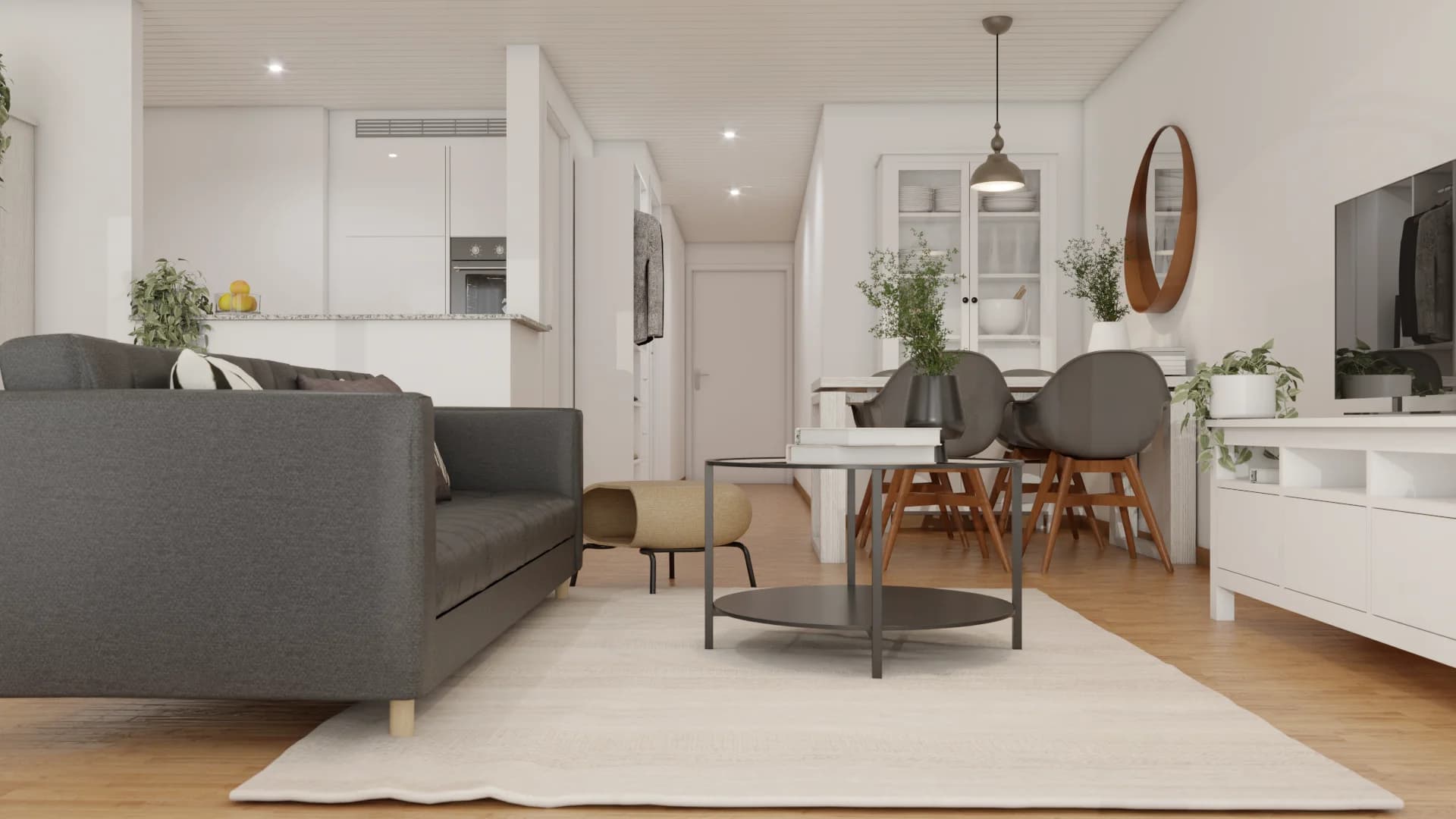Open-plan studio with herringbone oak floors, gray sofa, shell dining chairs, walnut oval mirror, and white glass cabinet