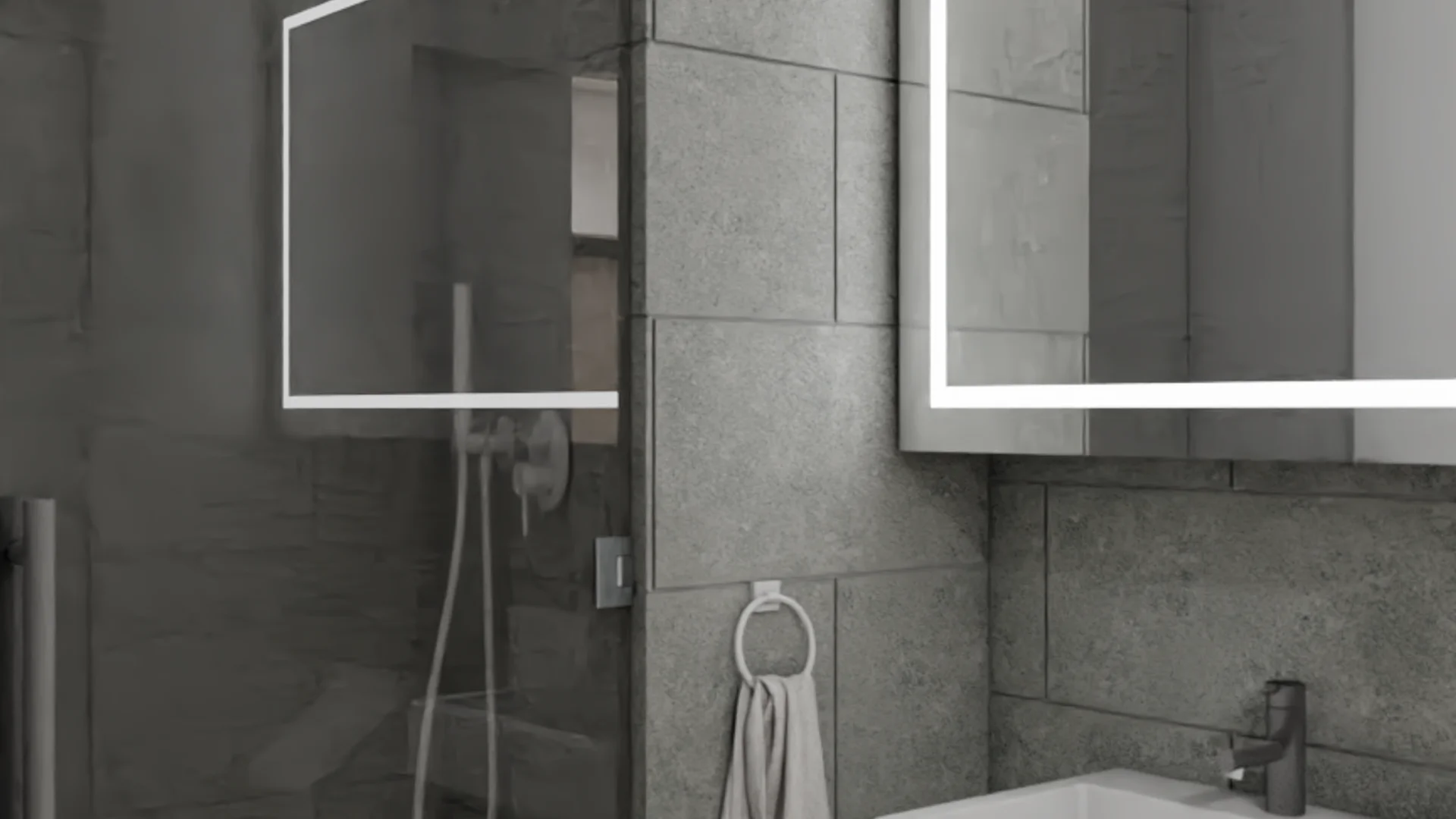 Glass shower enclosure with rainfall head beside LED-lit mirror and gray large-format porcelain tile
