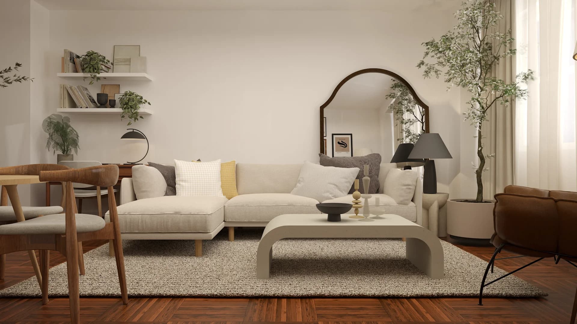 Cream sectional with plaster coffee table, arched walnut mirror, and indoor plants in open studio