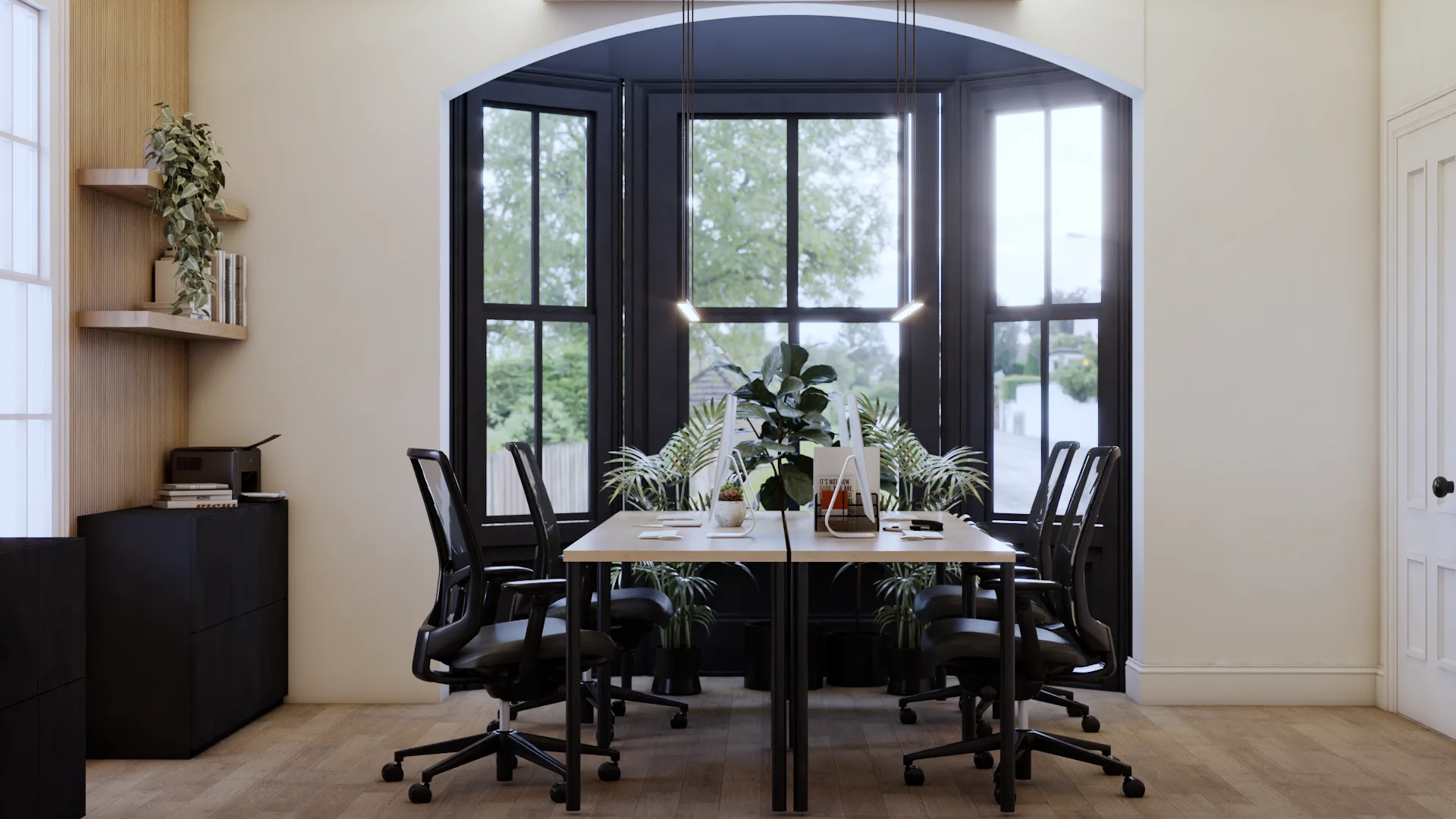 Collaborative team office with a large arched black-frame bay window, light oak worktable, six black mesh chairs, wood slat accent wall with floating shelves, and lush indoor plants. Design by Debora, an online interior design service.