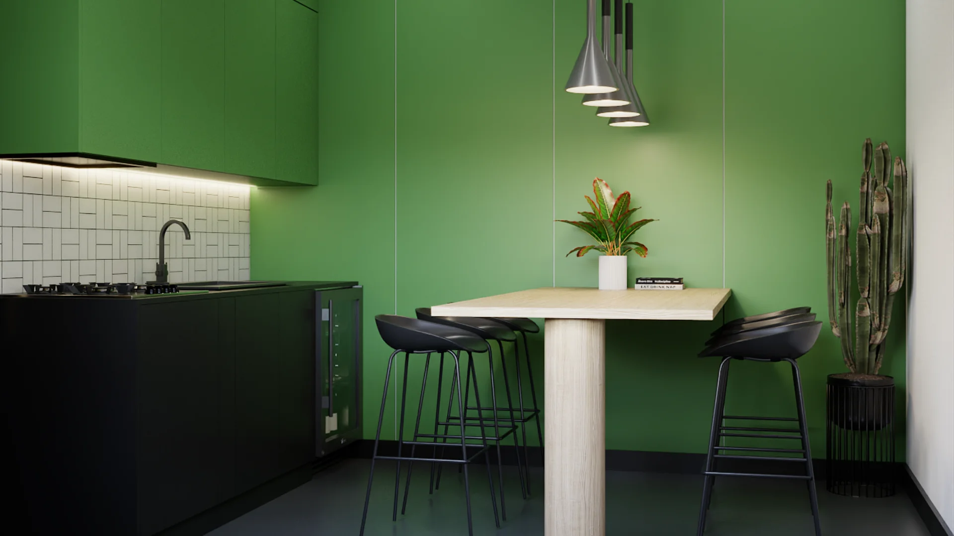 Green office break room with black cabinetry, wood bar table, and metal pendant lights