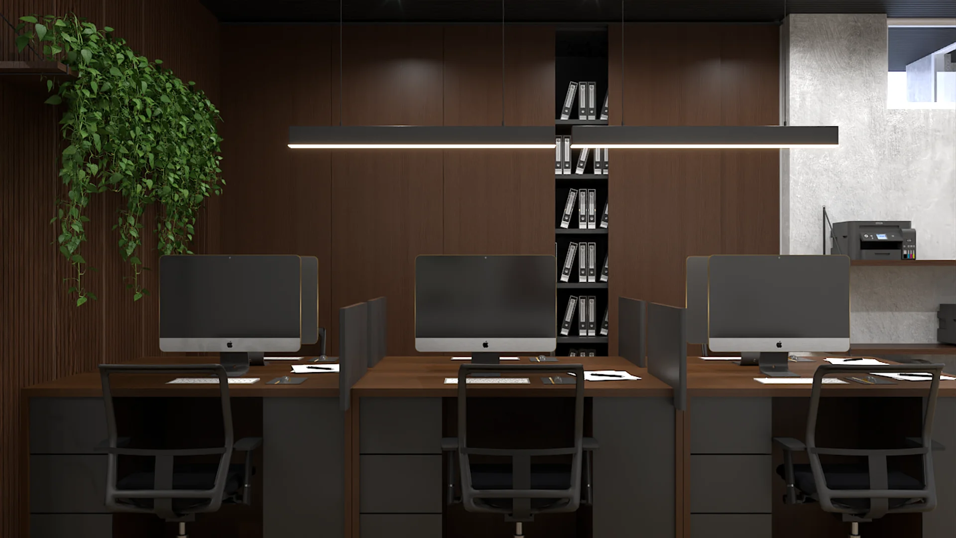 Three-desk walnut workstation with black linear pendant light and trailing plant shelf