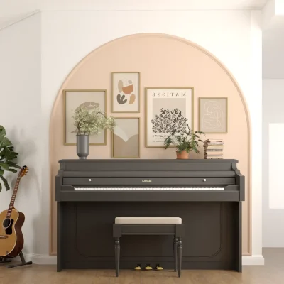 A stylish music nook with a chic piano, soft pink accent wall, and modern artwork. A guitar and potted plants add to the inspiring atmosphere. Design by Debora, an online interior design service.