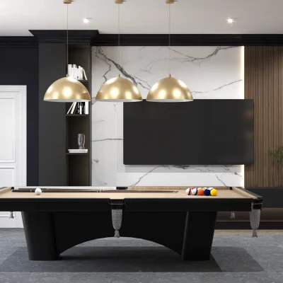 A modern game room with a sleek pool table, gold pendant lights, and a marble accent wall. The design includes a black shelving unit with decor and books. Design by Debora, an online interior design service.
